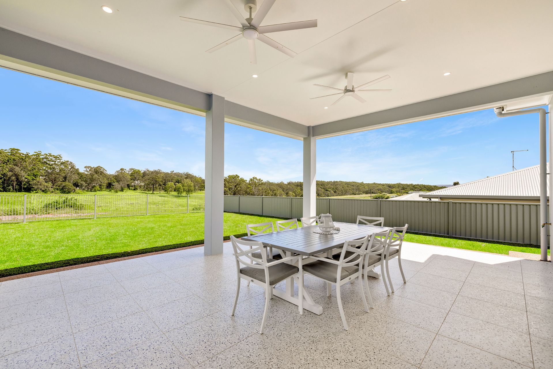  Overlooking a Green Grassy Field and Trees Under a Clear Blue Sky — Ashlee Jones Homes in Gordonvale, QLD
