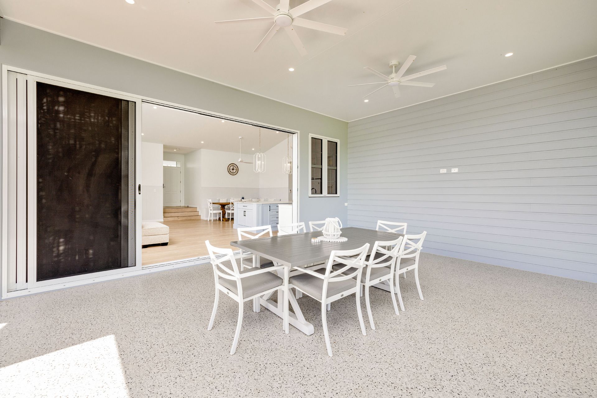 Outdoor Patio With a Grey Dining Set and Chairs — Ashlee Jones Homes in Gordonvale, QLD