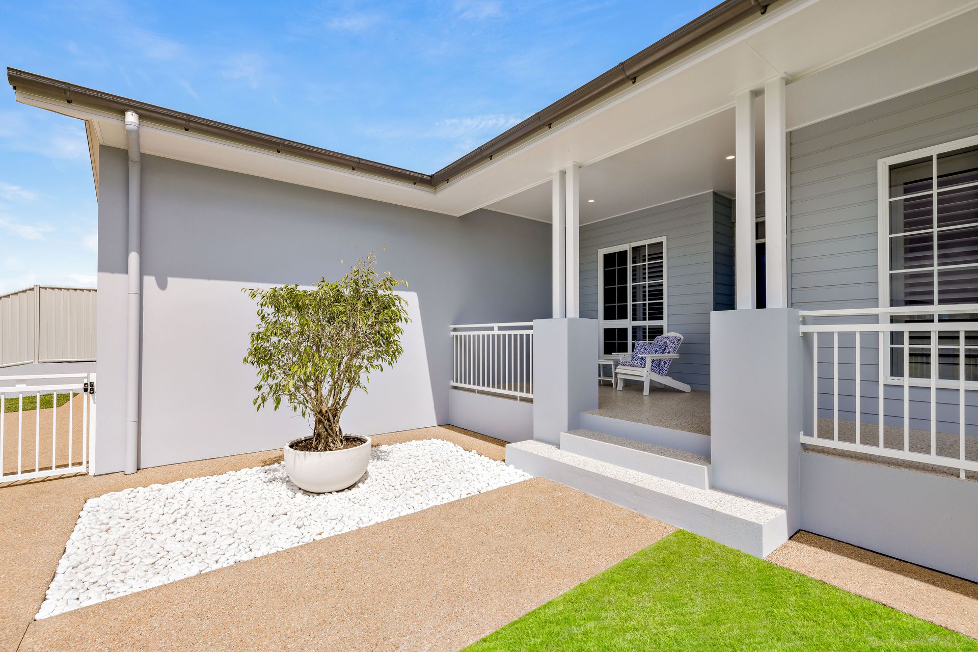 A Modern Grey House Exterior Featuring a Small Porch — Ashlee Jones Homes in Gordonvale, QLD