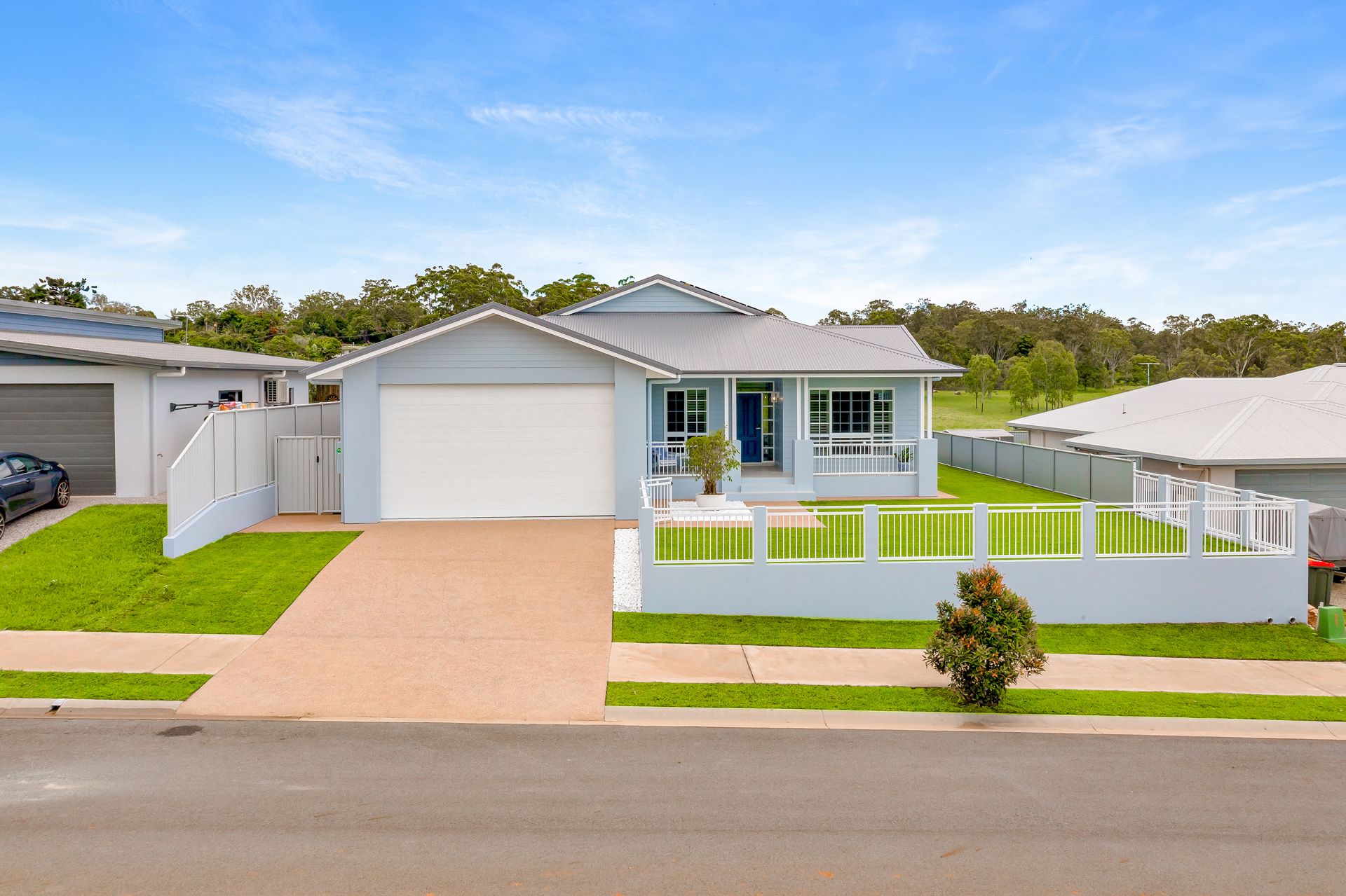 A Single-story, Light Blue House With a White Garage — Ashlee Jones Homes in Gordonvale, QLD