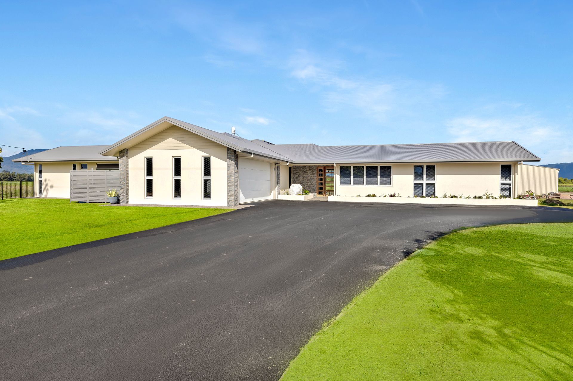 A Single-story, Light-colored Modern House With a Grey Roof — Ashlee Jones Homes in Gordonvale, QLD