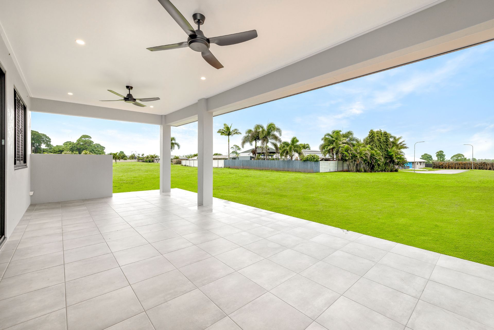 Spacious Covered Patio With Light Grey Tiled Floor — Ashlee Jones Homes in Gordonvale, QLD