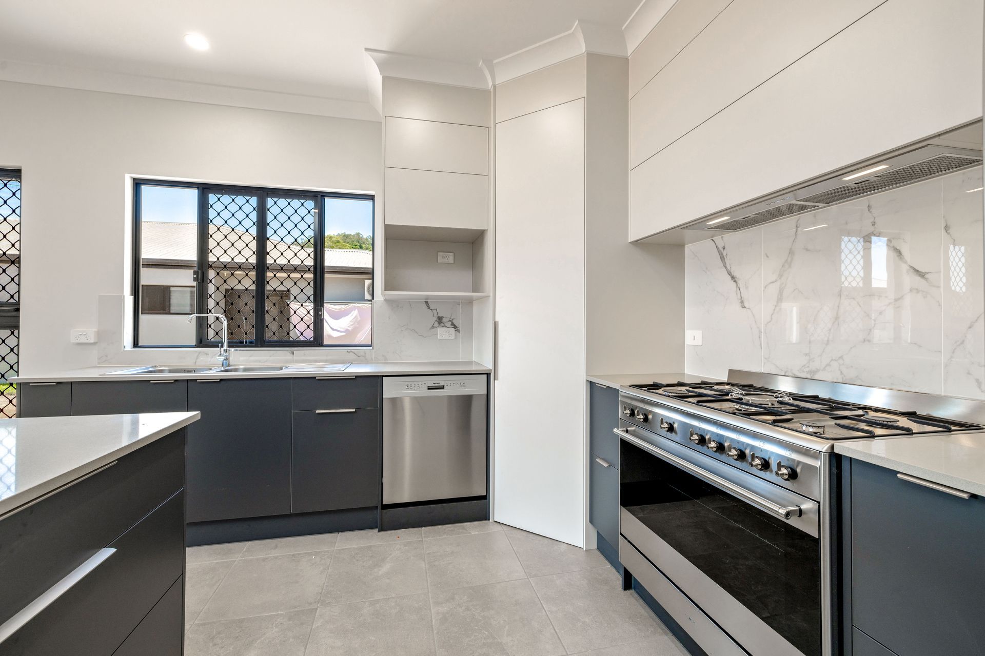 Modern Kitchen Featuring Dark Grey Cabinets — Ashlee Jones Homes in Gordonvale, QLD