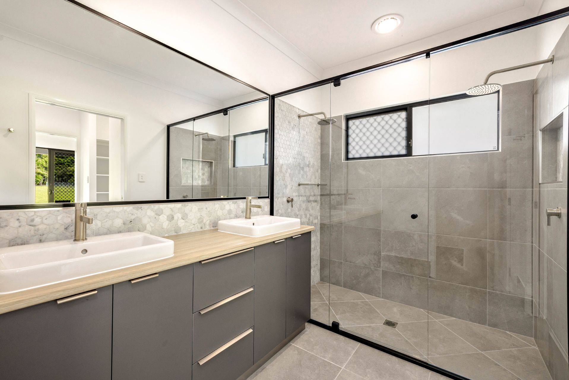 Modern Bathroom With a Double Vanity, Grey Cabinets — Ashlee Jones Homes in Gordonvale, QLD