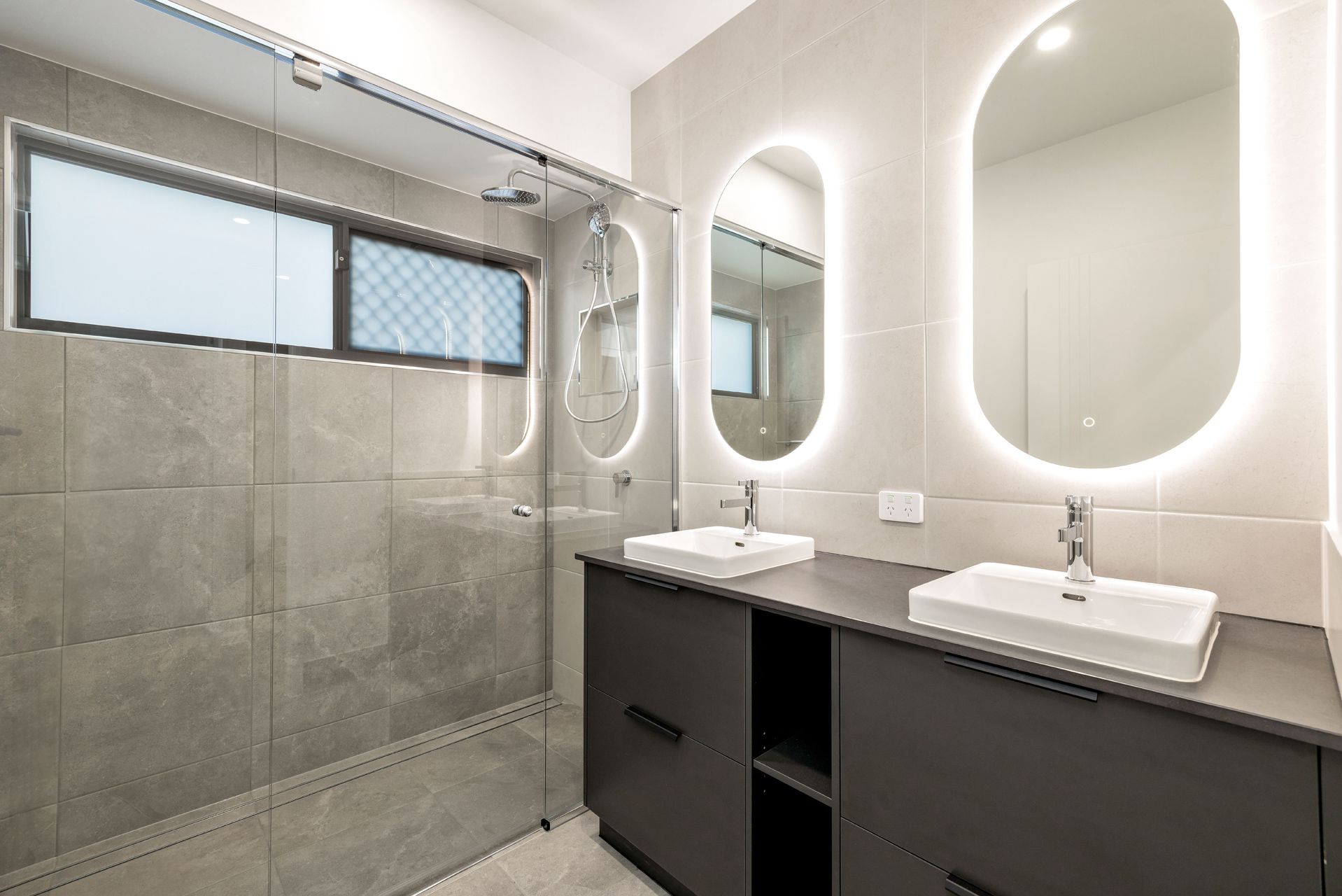 Modern Bathroom With a Double Vanity, Charcoal Cabinets — Ashlee Jones Homes in Gordonvale, QLD