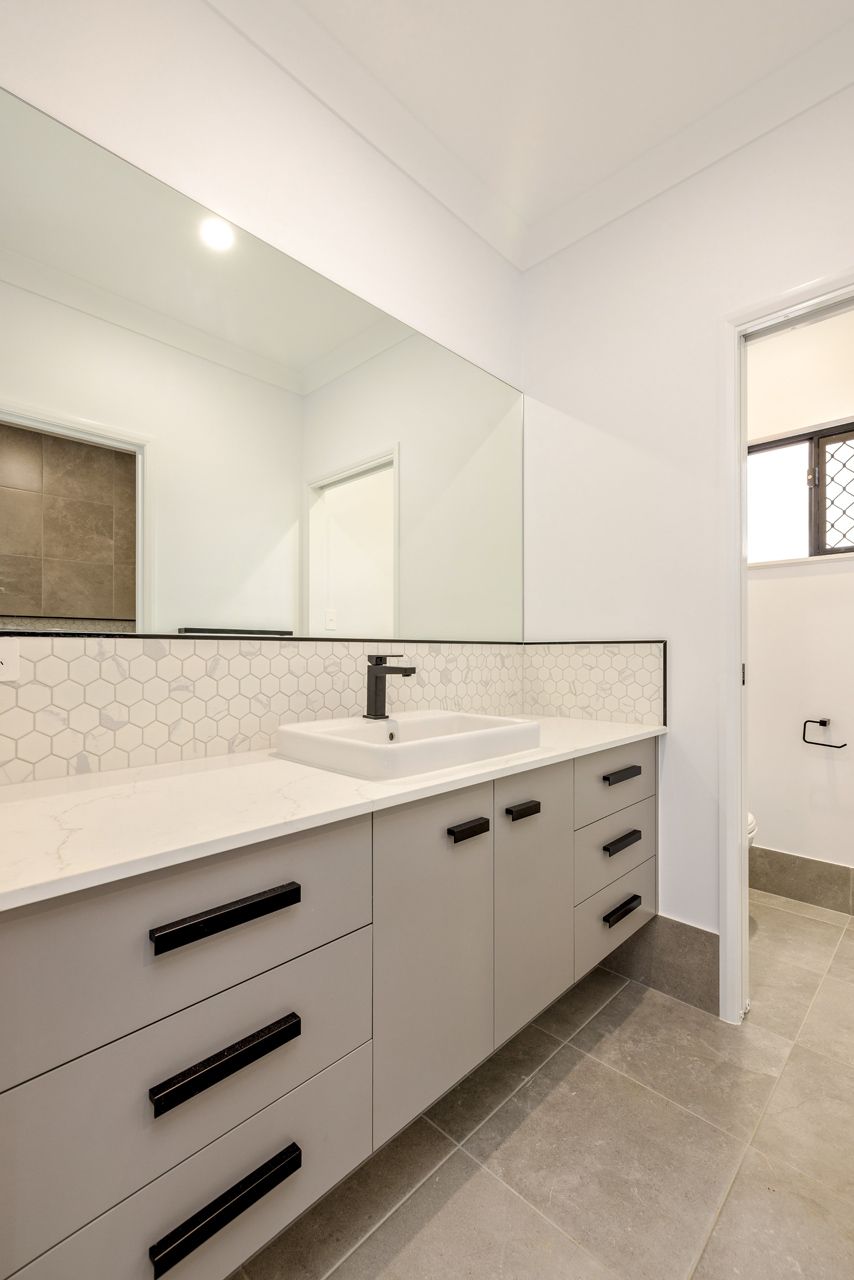 Modern Bathroom Vanity With Light Gray Cabinets — Ashlee Jones Homes in Gordonvale, QLD