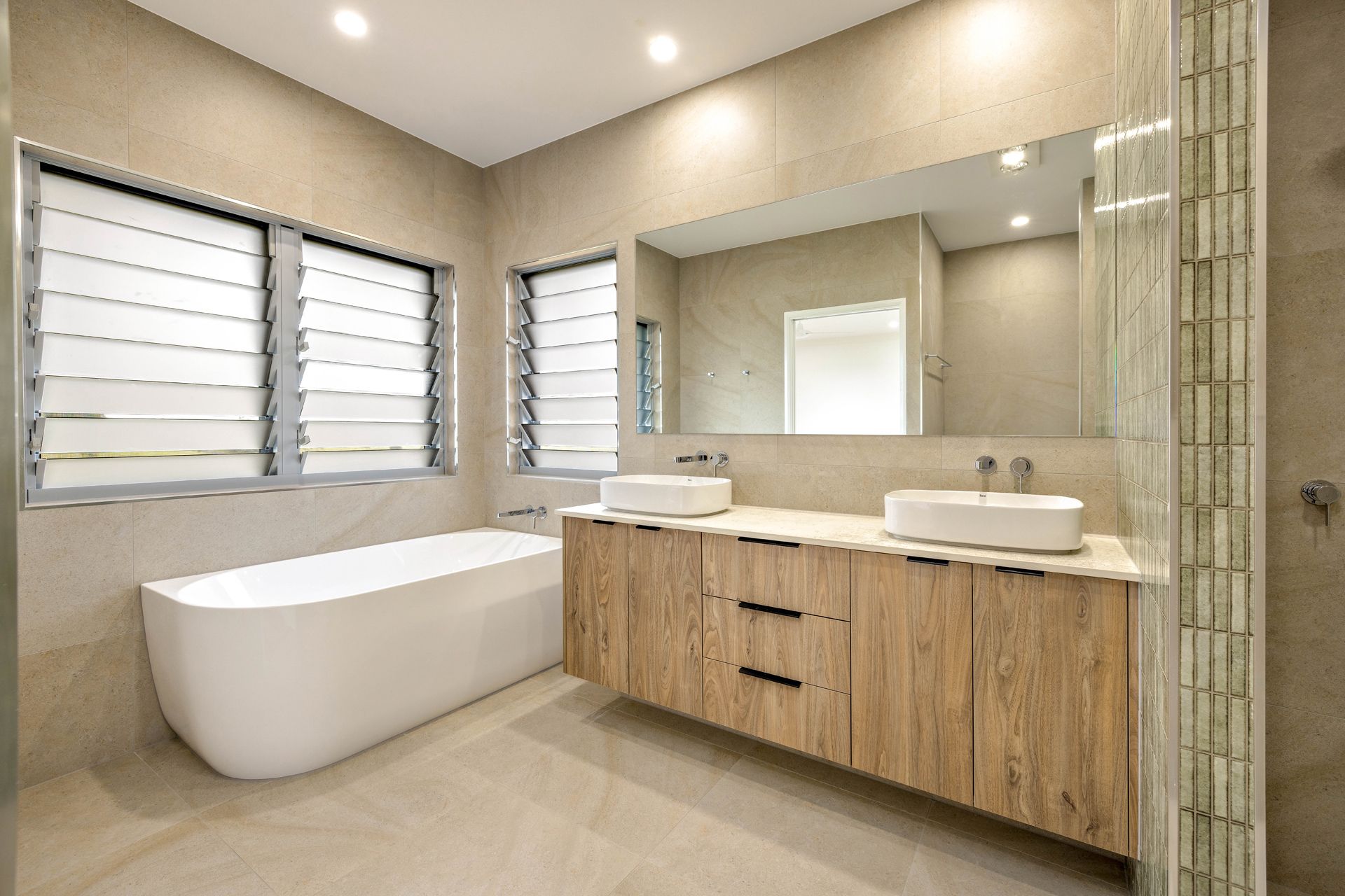A Modern Bathroom With a Freestanding White Tub — Ashlee Jones Homes in Gordonvale, QLD