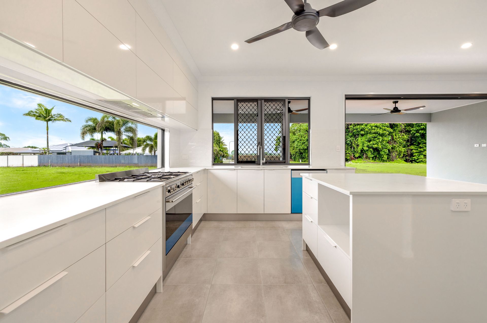A Modern Kitchen Featuring White Cabinets — Ashlee Jones Homes in Gordonvale, QLD