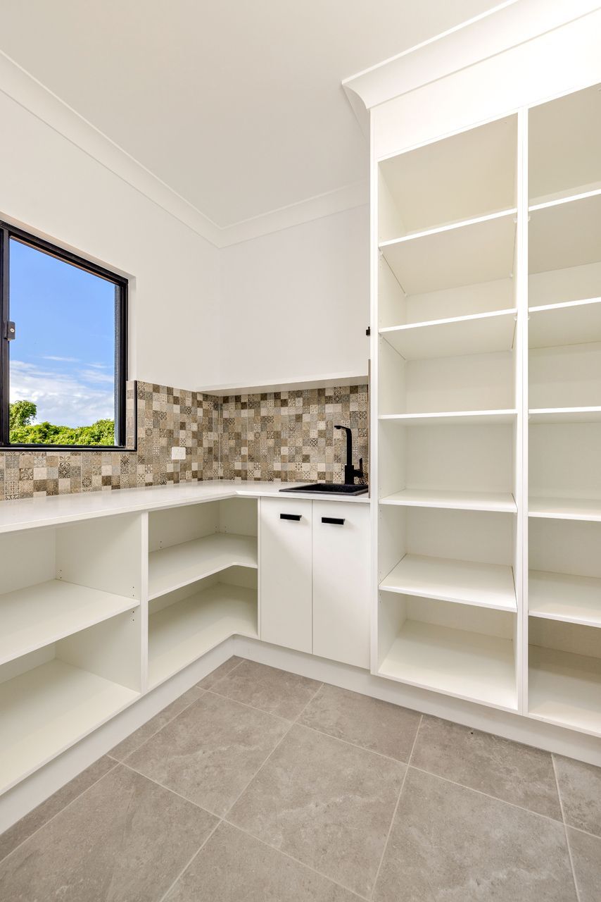 A White Kitchen Pantry With Open Shelving — Ashlee Jones Homes in Gordonvale, QLD