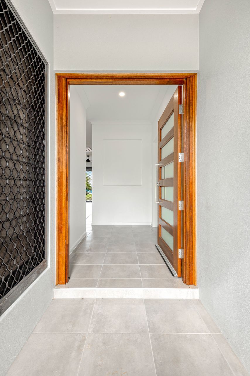 A Modern Entryway With Light Gray Tiled Floors — Ashlee Jones Homes in Gordonvale, QLD