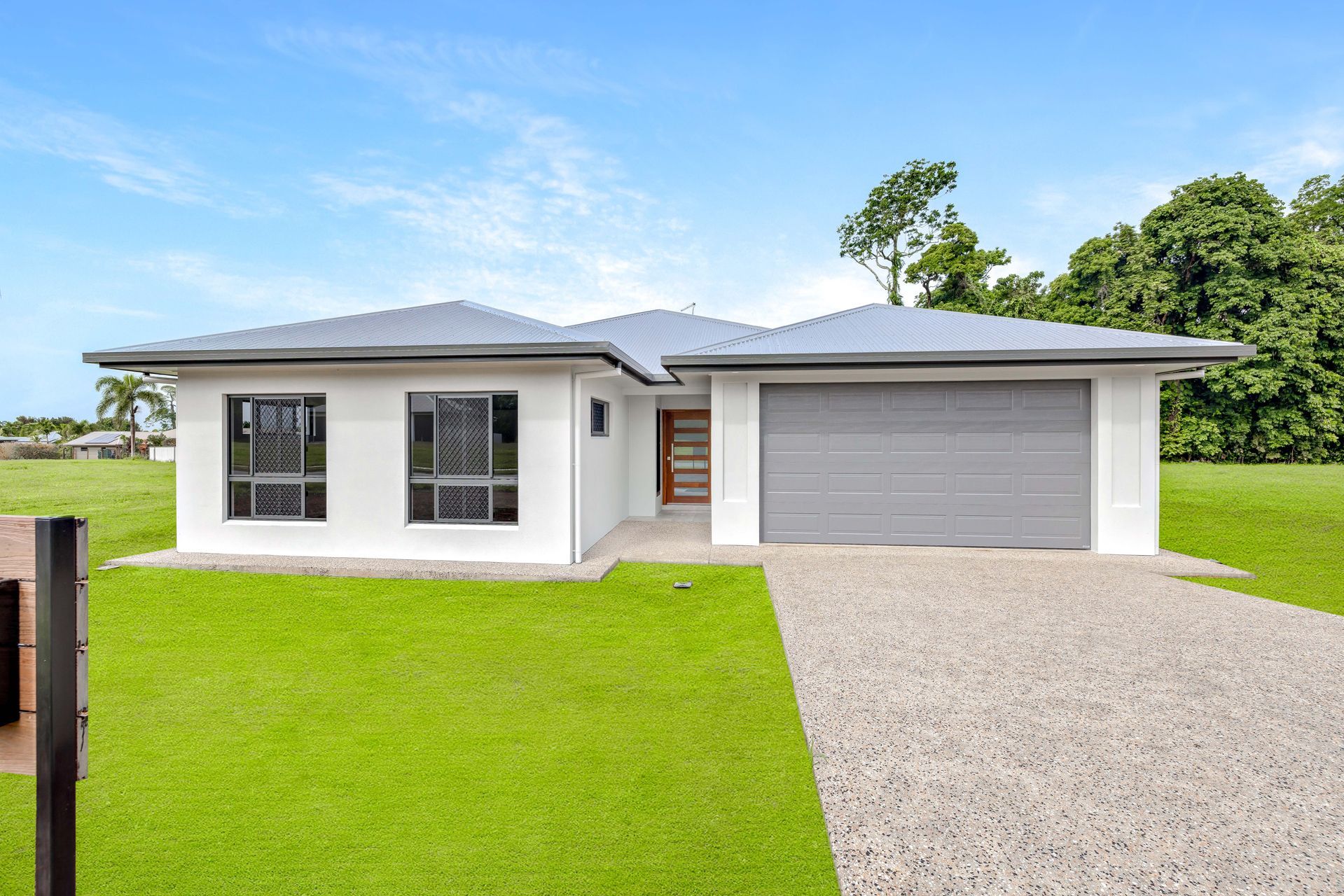 A Modern, One-story White House With a Grey Roof and Garage — Ashlee Jones Homes in Gordonvale, QLD