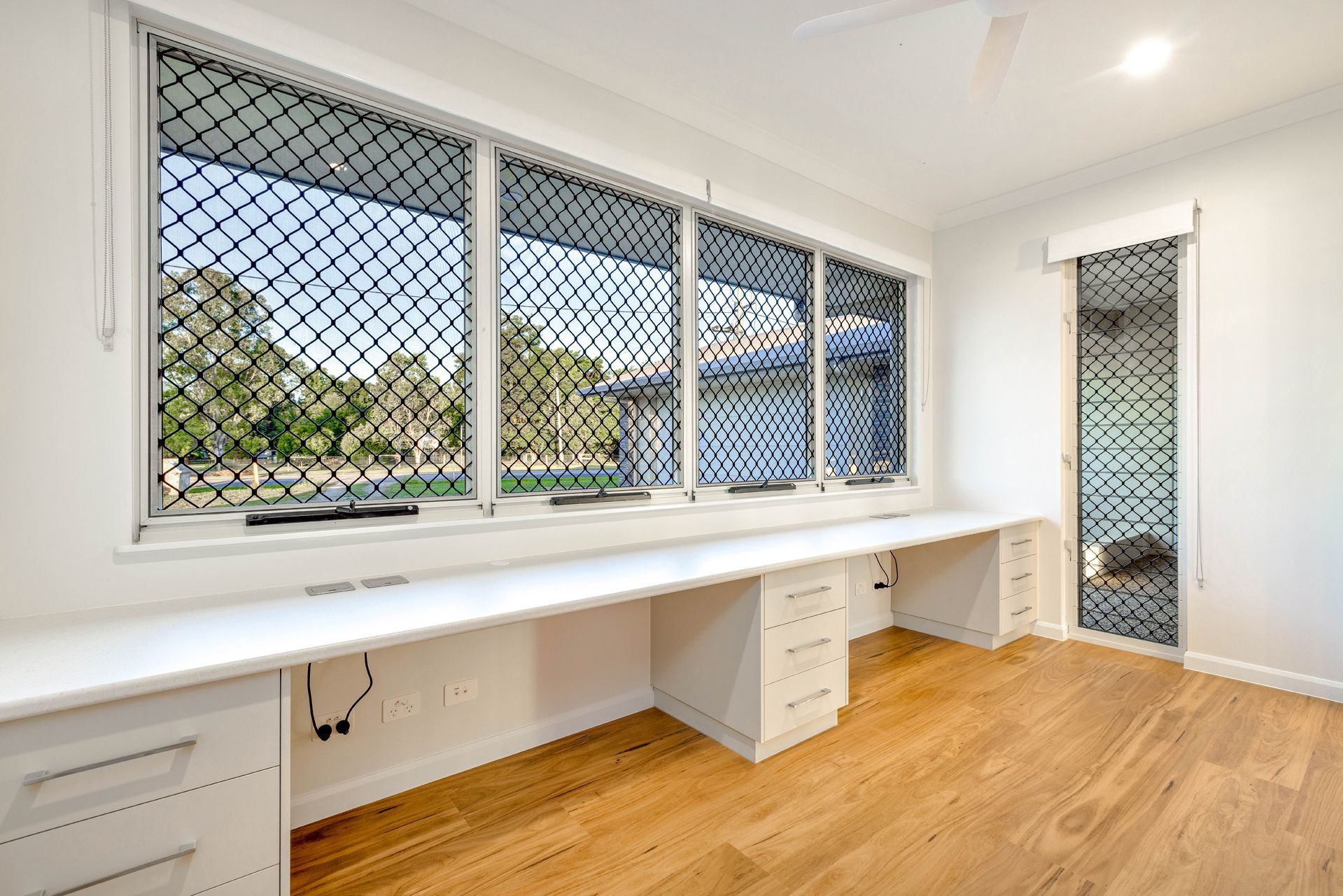 A Bright Office With a Long, Built-in White Desk — Ashlee Jones Homes in Gordonvale, QLD