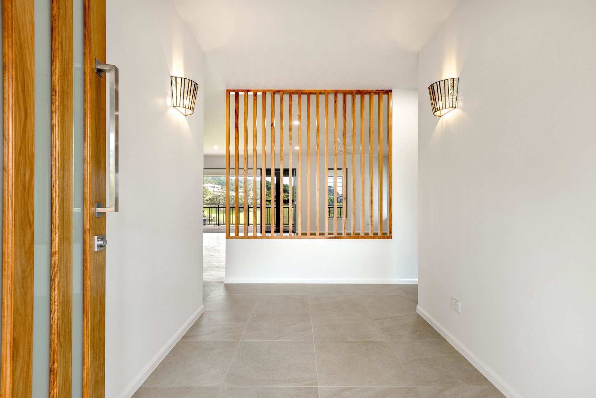 A Bright, Modern Entryway With White Walls — Ashlee Jones Homes in Gordonvale, QLD