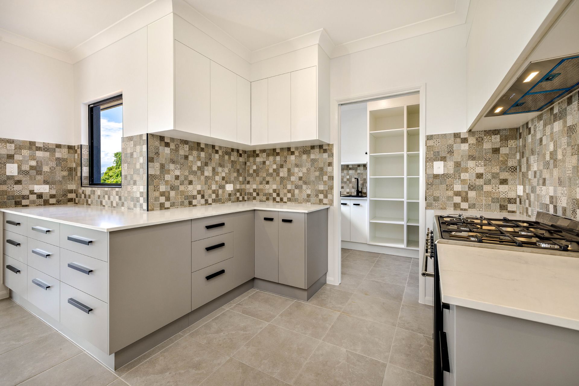 Modern Kitchen With Grey Cabinets, White Countertops — Ashlee Jones Homes in Gordonvale, QLD