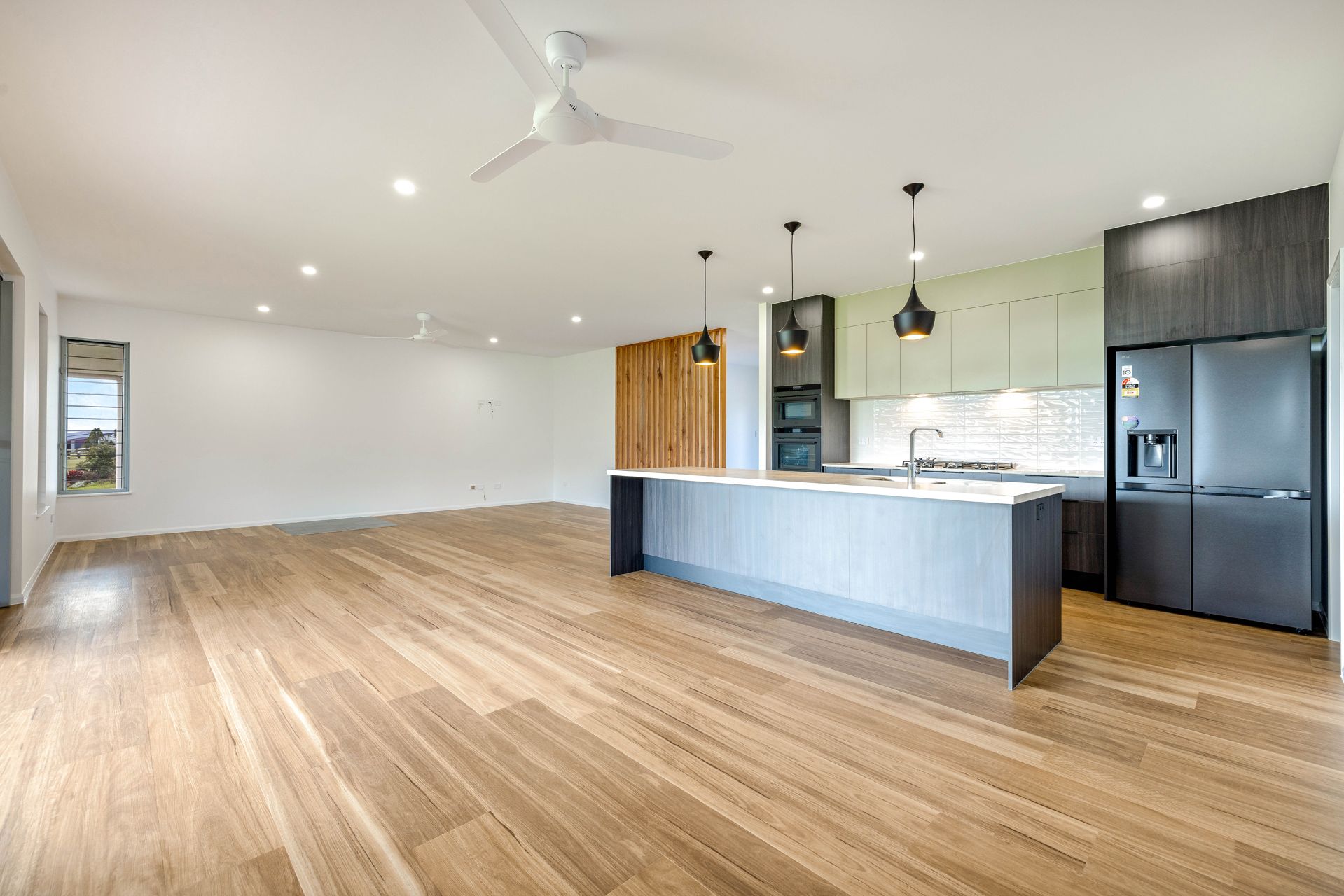 Modern Open-plan Kitchen With Light Wood Floors — Ashlee Jones Homes in Gordonvale, QLD