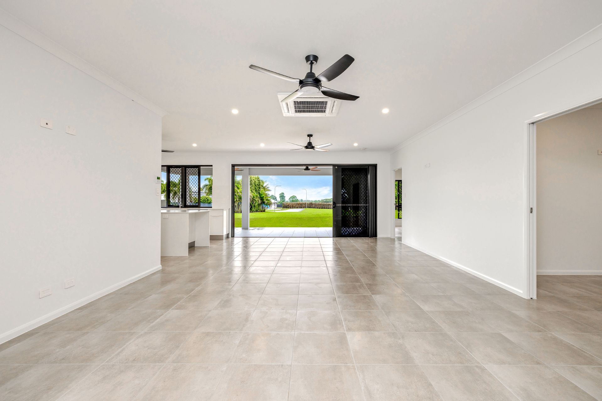 An Open-plan, Unfurnished Living Room With White Walls — Ashlee Jones Homes in Gordonvale, QLD