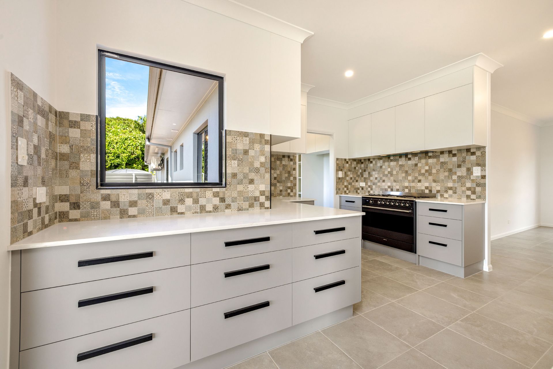 Modern Kitchen With Light Gray Cabinets, Black Hardware — Ashlee Jones Homes in Gordonvale, QLD