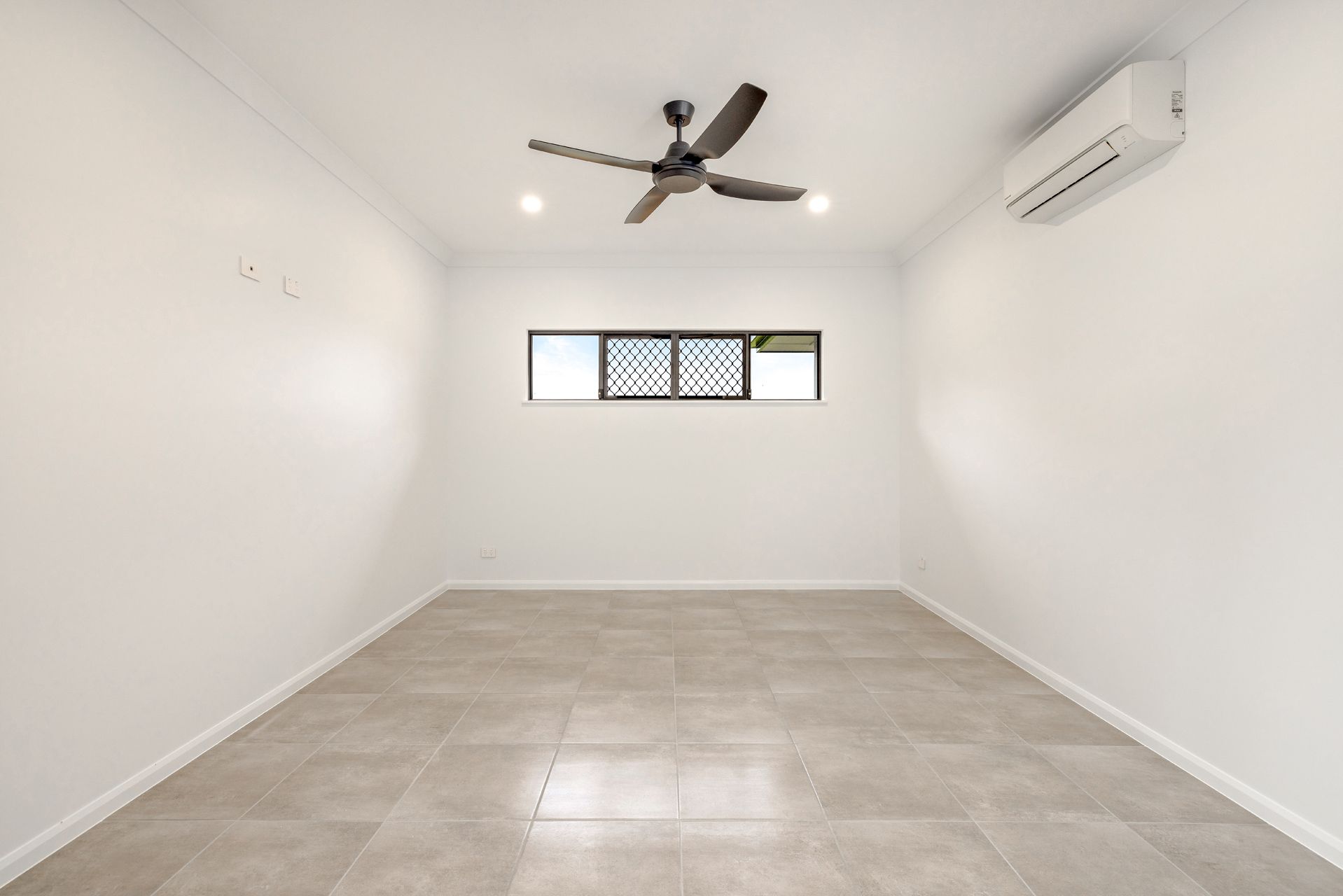 An Empty Room With White Walls, Light Tile Flooring — Ashlee Jones Homes in Gordonvale, QLD