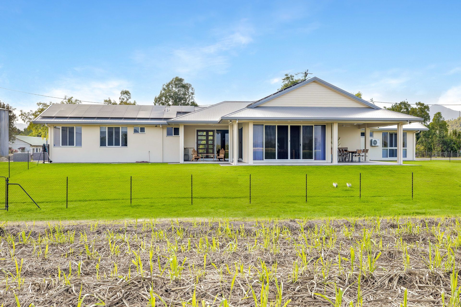 A Light-colored, Single-story House With a Covered Patio — Ashlee Jones Homes in Gordonvale, QLD