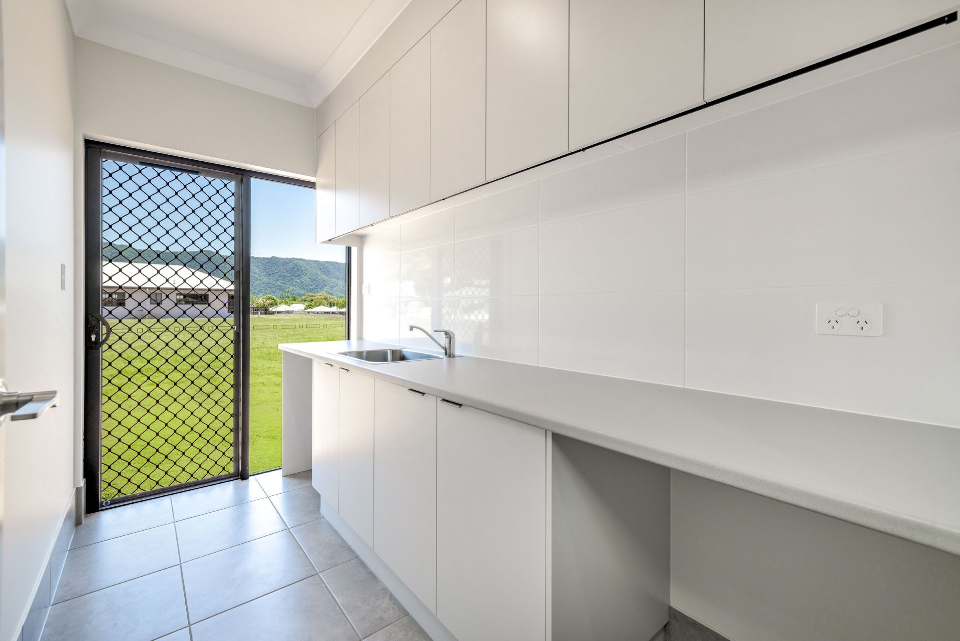 Modern, White Minimalist Kitchen With Grey Tiled Floors — Ashlee Jones Homes in Gordonvale, QLD