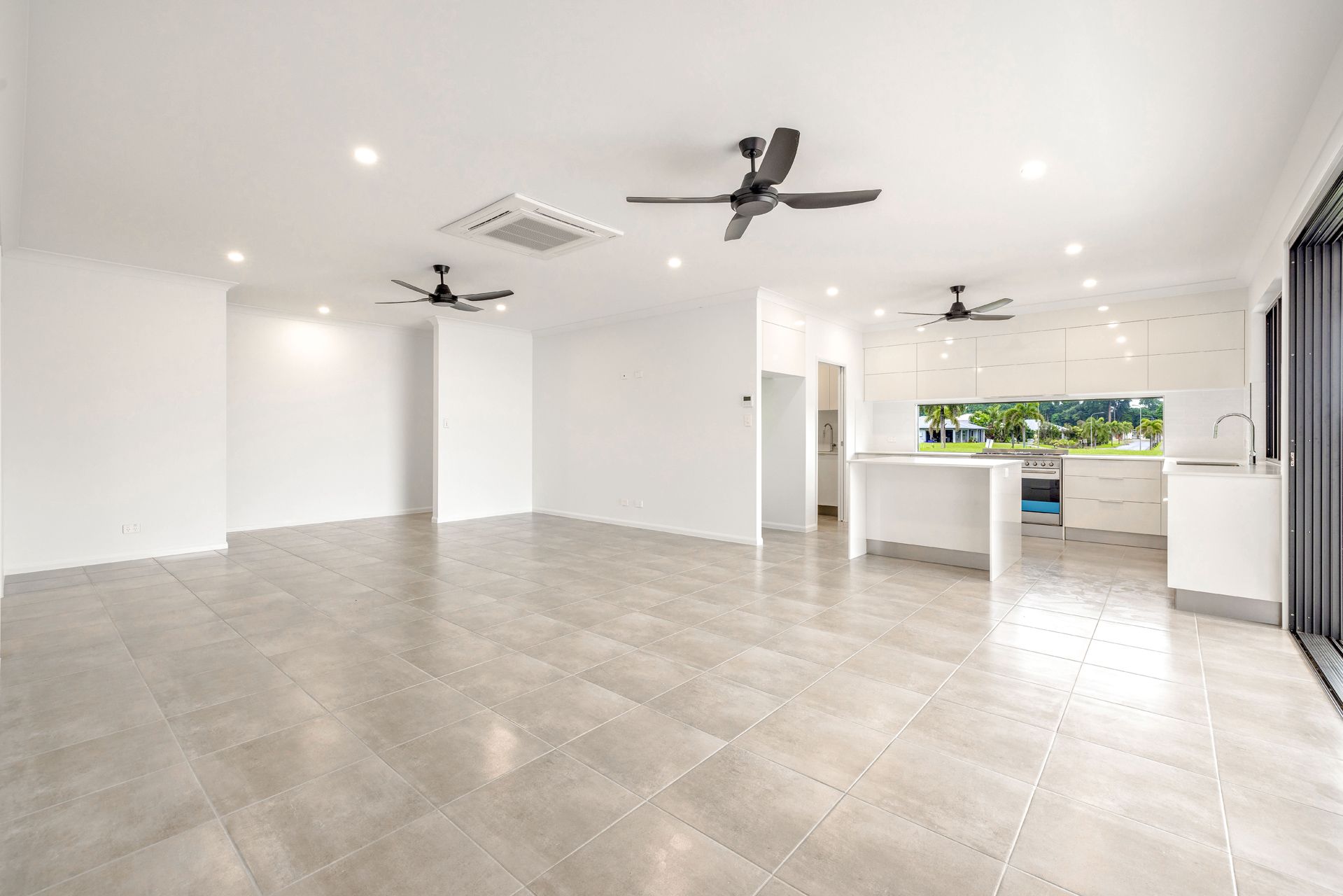A Spacious, Modern Open-plan Room With White Walls — Ashlee Jones Homes in Gordonvale, QLD