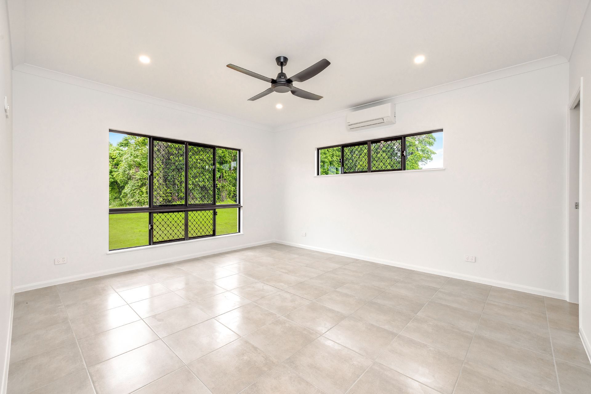 An Empty Room With White Walls, Light-colored Tile Floors — Ashlee Jones Homes in Gordonvale, QLD