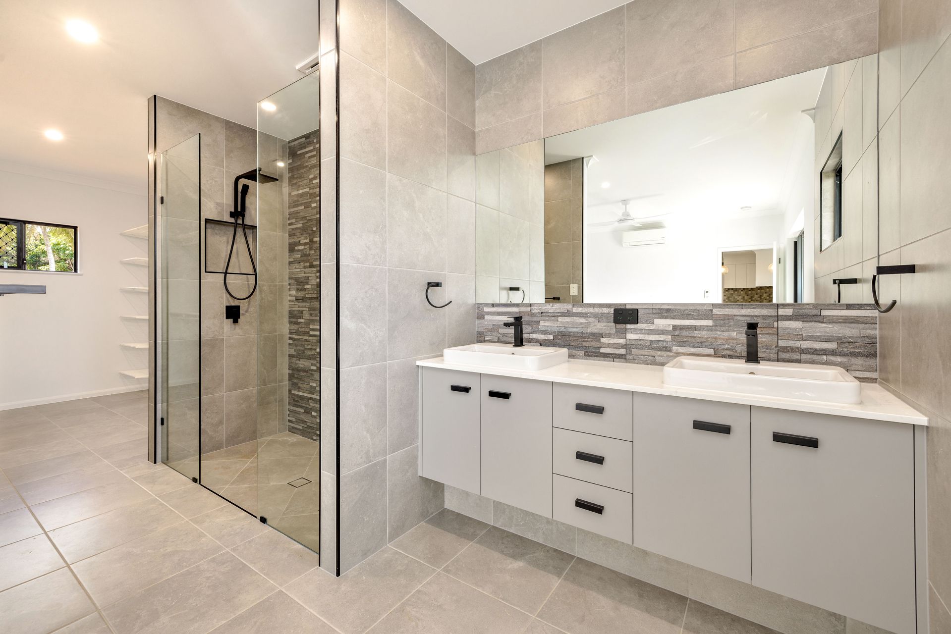 A Modern Bathroom With a Double Vanity, a Glass-enclosed Shower — Ashlee Jones Homes in Gordonvale, QLD