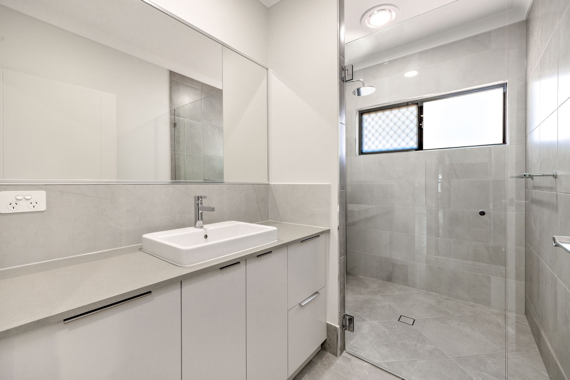 Modern Bathroom With a White Vanity, Countertop Sink — Ashlee Jones Homes in Gordonvale, QLD