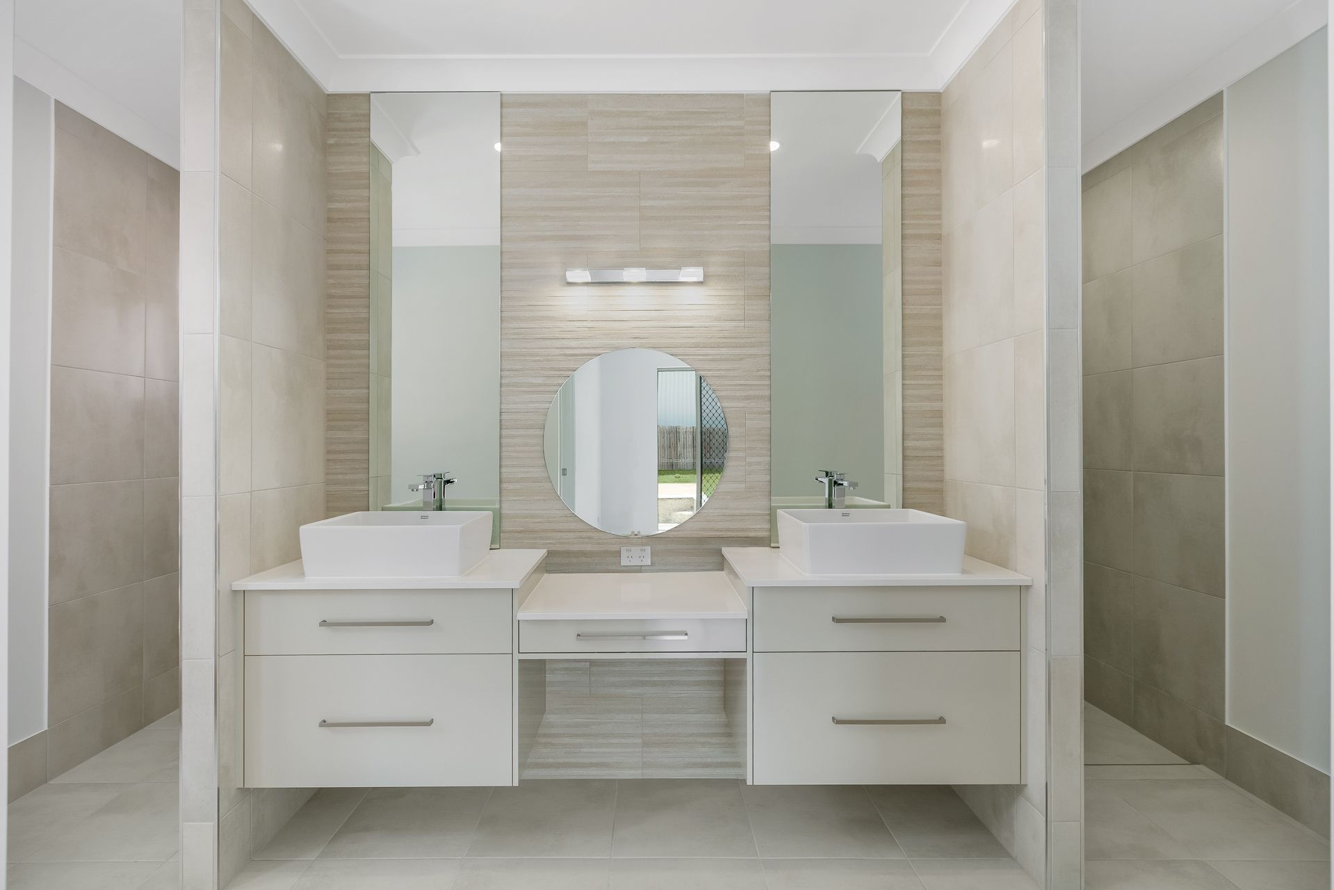 A Modern Double Vanity in a Tiled Bathroom With Two White Vessel Sinks — Ashlee Jones Homes in Gordonvale, QLD