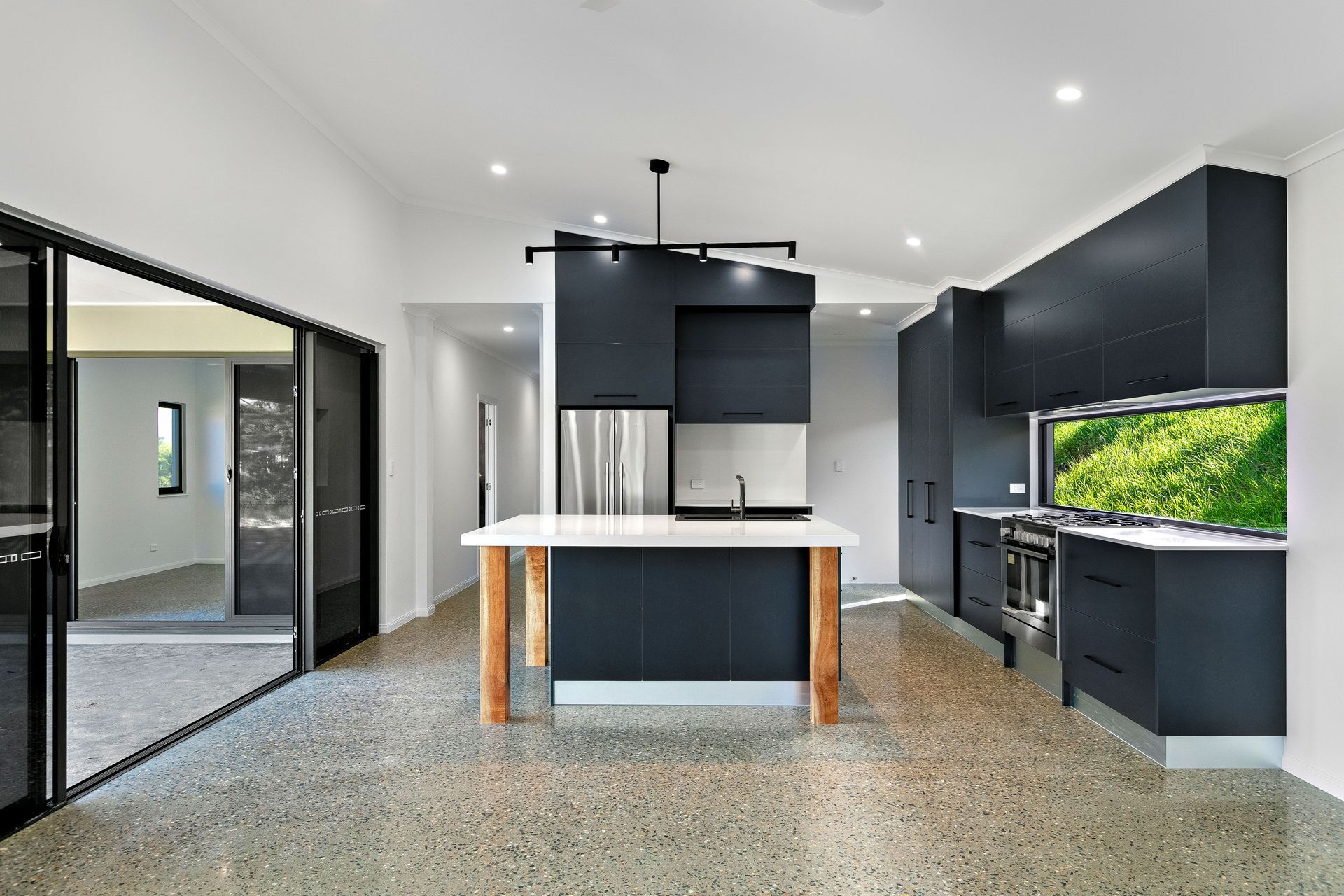 Modern Kitchen With Matte Black Cabinetry — Ashlee Jones Homes in Gordonvale, QLD