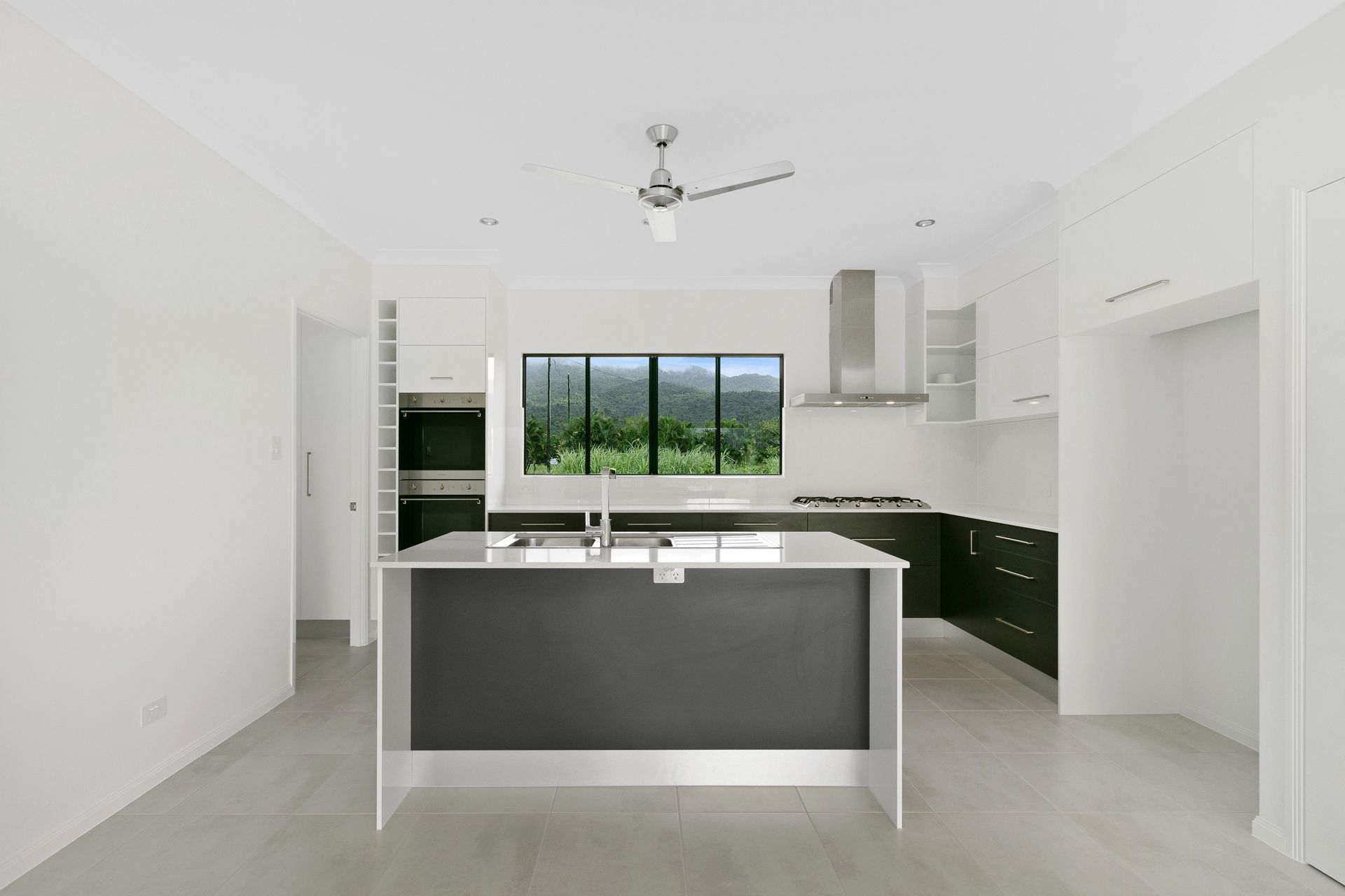 Modern Kitchen With a Central Dark-gray Island — Ashlee Jones Homes in Gordonvale, QLD