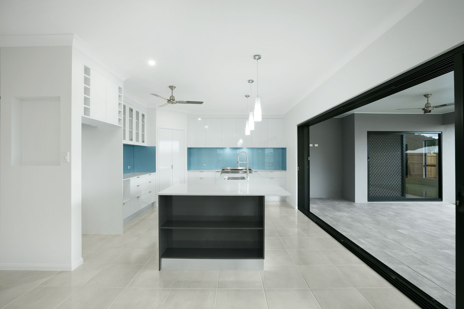 Modern Kitchen With a White Island, Blue Backsplash — Ashlee Jones Homes in Gordonvale, QLD