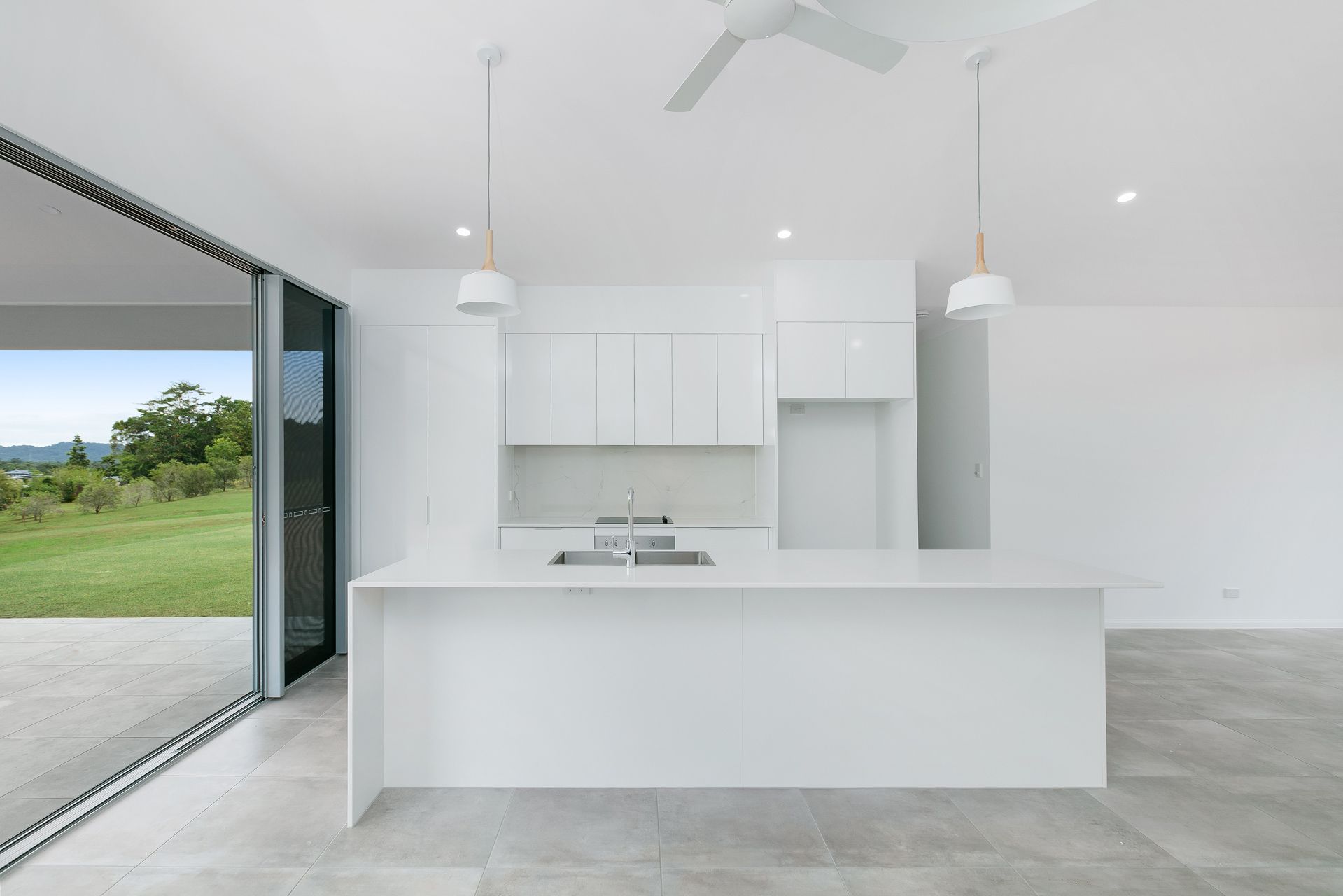 Modern, Minimalist White Kitchen With a Central Island — Ashlee Jones Homes in Gordonvale, QLD