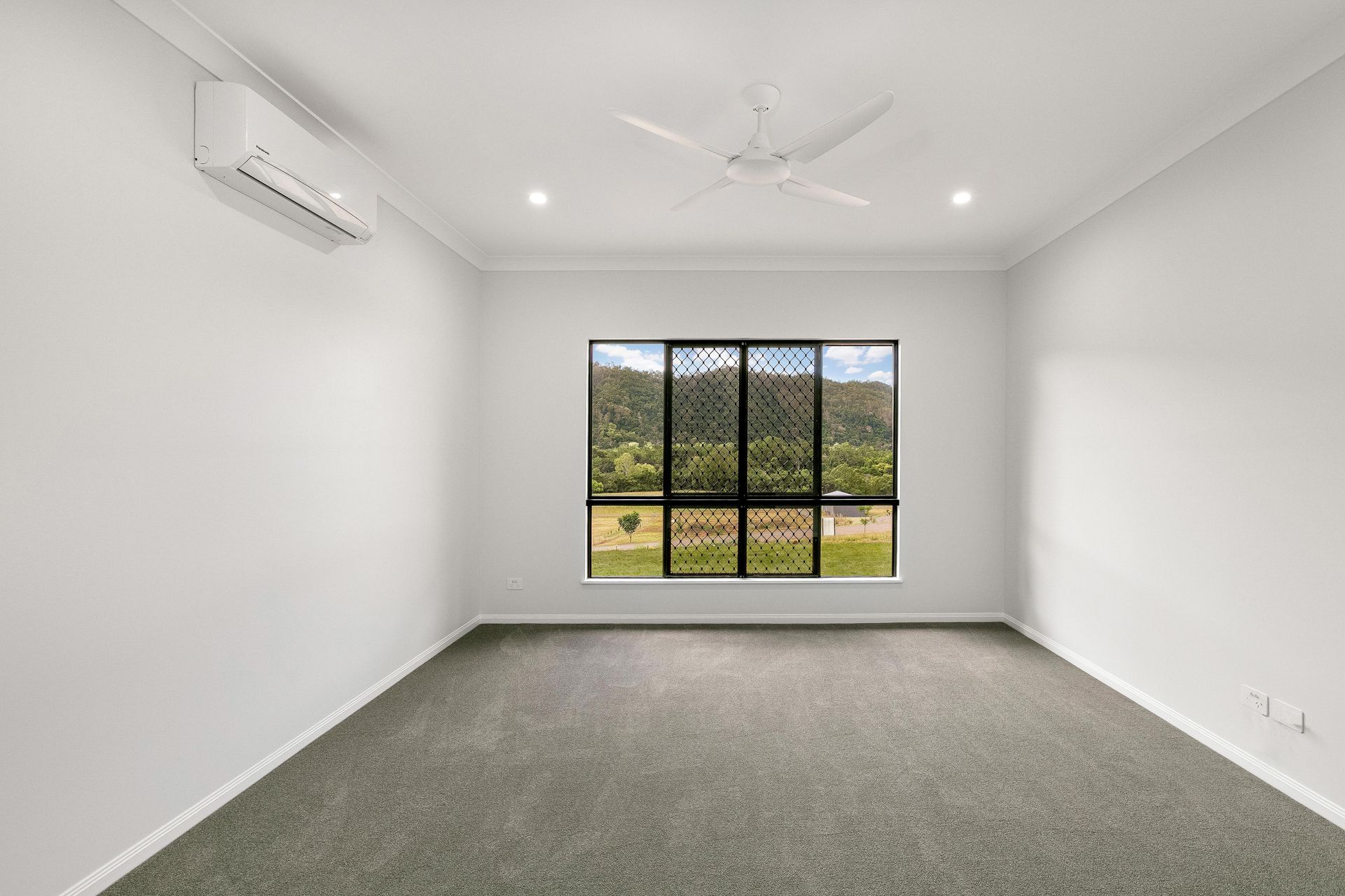 Empty Bedroom With Plain White Walls, Gray Carpet — Ashlee Jones Homes in Gordonvale, QLD
