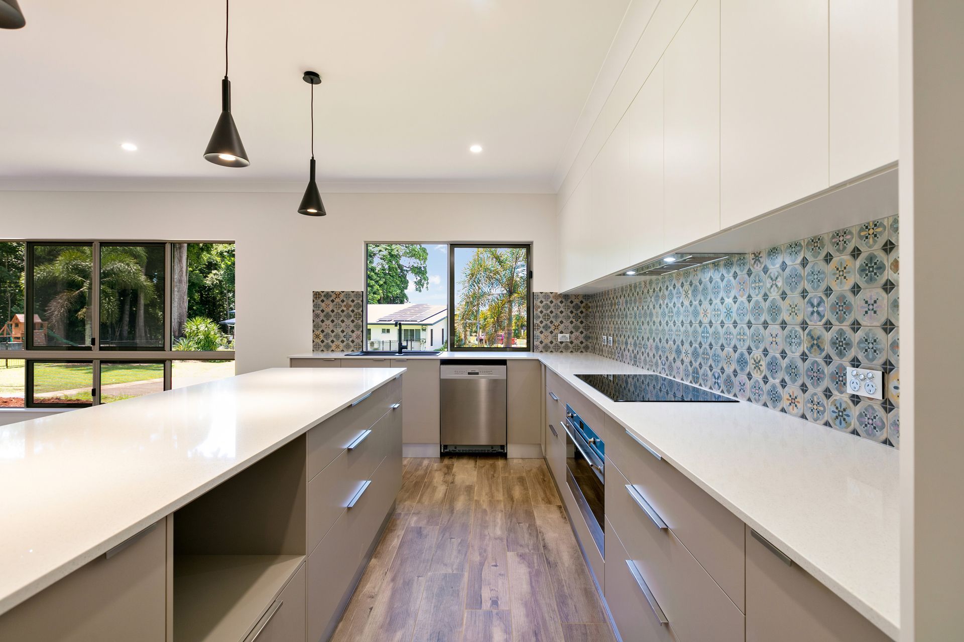A Modern Kitchen With White Countertops — Ashlee Jones Homes in Gordonvale, QLD