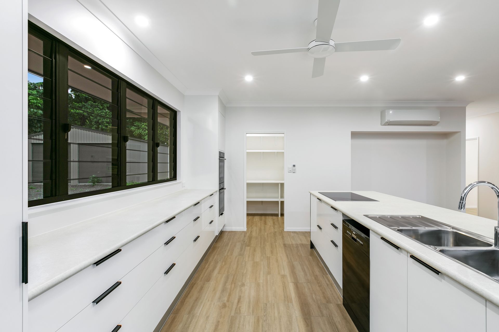 Modern, Minimalist Kitchen With White Cabinets, and Dark Hardware — Ashlee Jones Homes in Gordonvale, QLD
