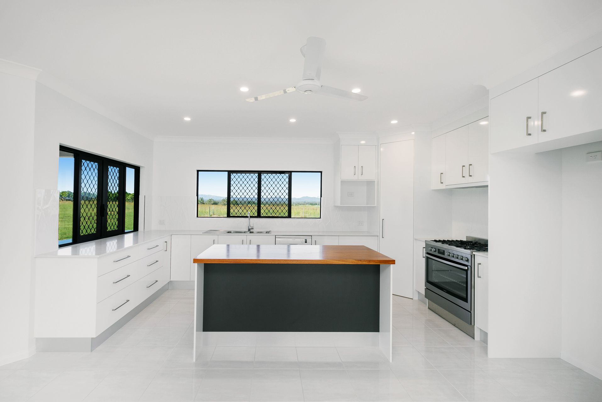 Modern White Kitchen With a Center Island — Ashlee Jones Homes in Gordonvale, QLD