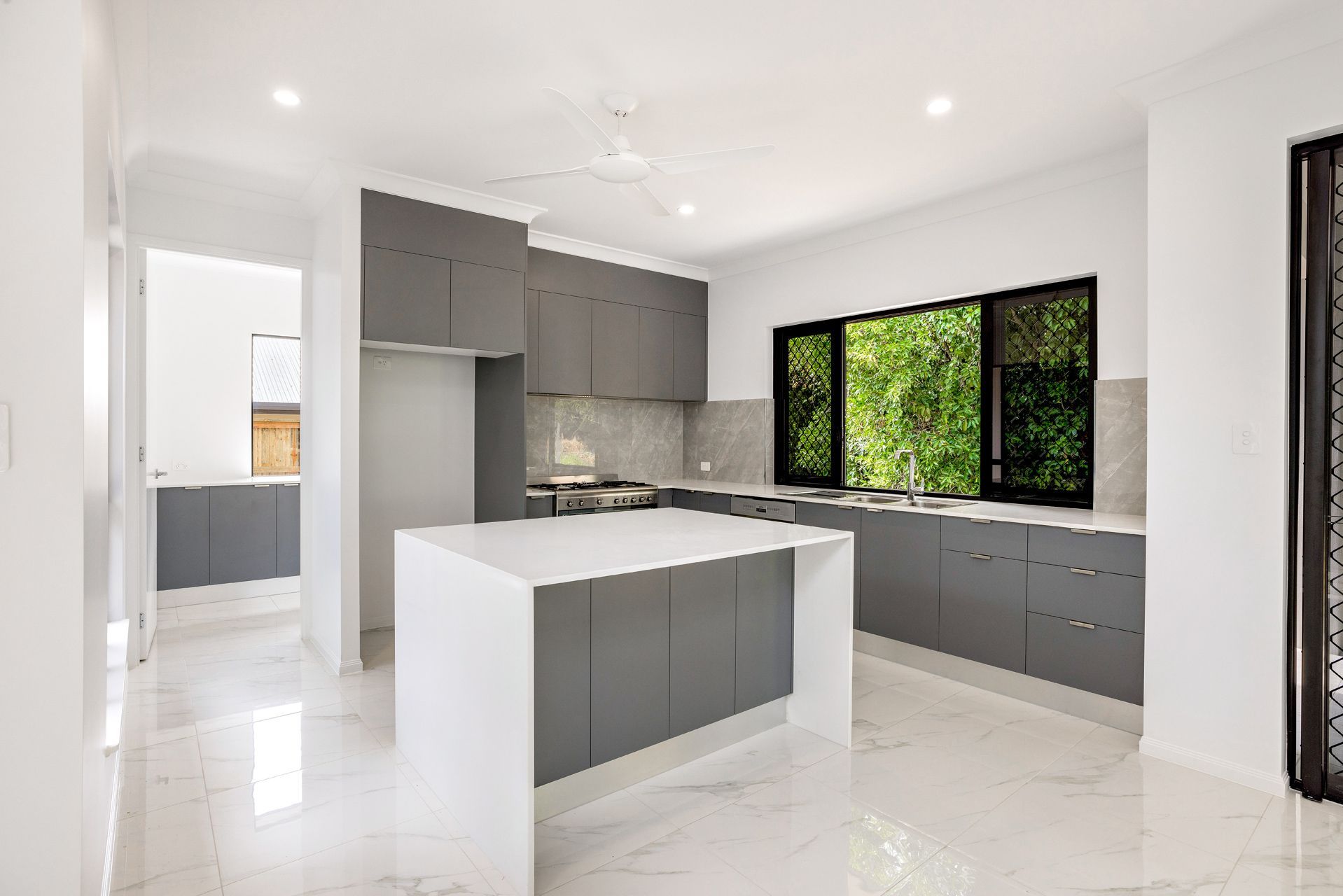 Modern Kitchen With a White Marble Floor, Gray Cabinets — Ashlee Jones Homes in Gordonvale, QLD