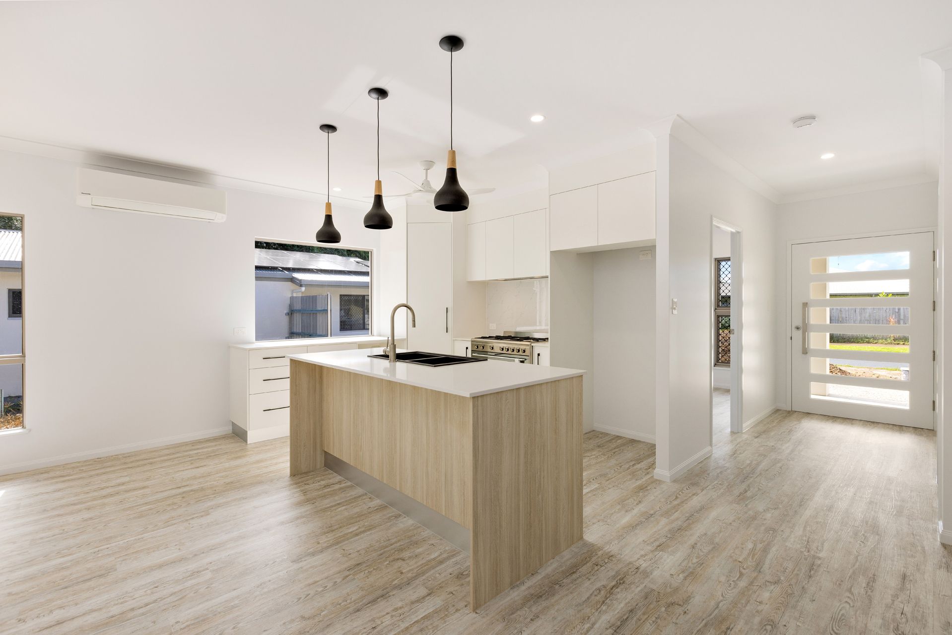 Modern Kitchen With Light Wood Island, White Cabinetry — Ashlee Jones Homes in Gordonvale, QLD