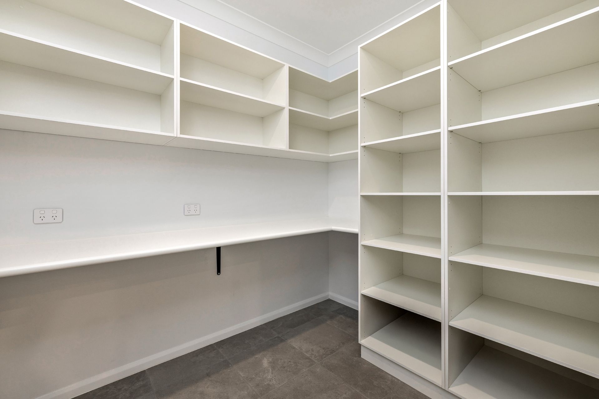 A Modern Walk-in Pantry With White Shelves — Ashlee Jones Homes in Gordonvale, QLD
