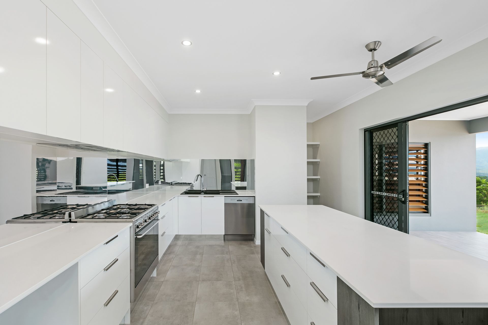 Modern Kitchen With White Cabinets, Light Quartz Countertops — Ashlee Jones Homes in Gordonvale, QLD