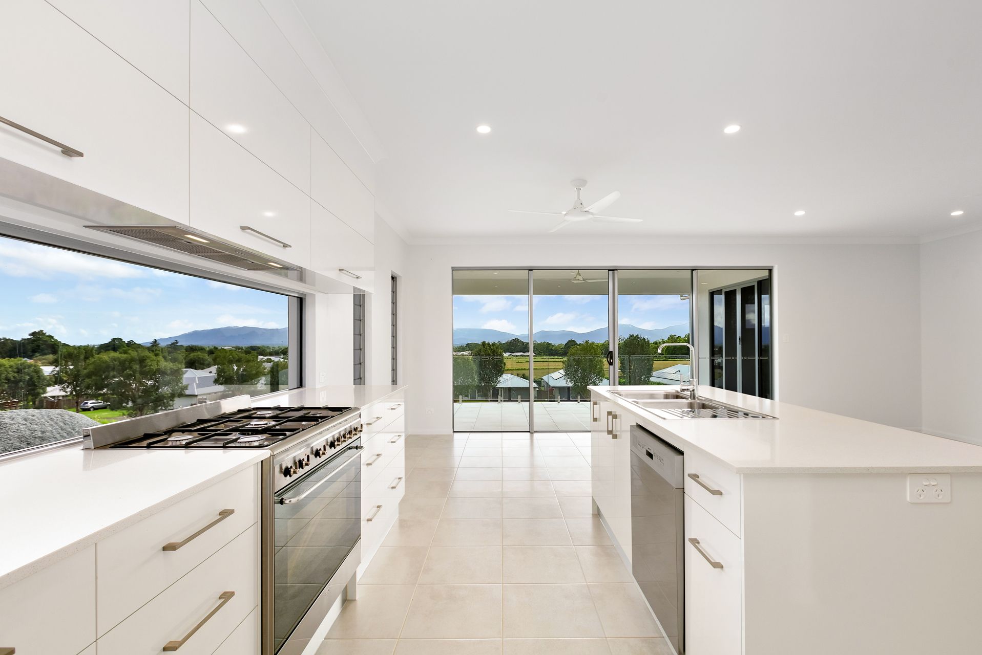 Modern White Kitchen With a Stove, Island Counter — Ashlee Jones Homes in Gordonvale, QLD