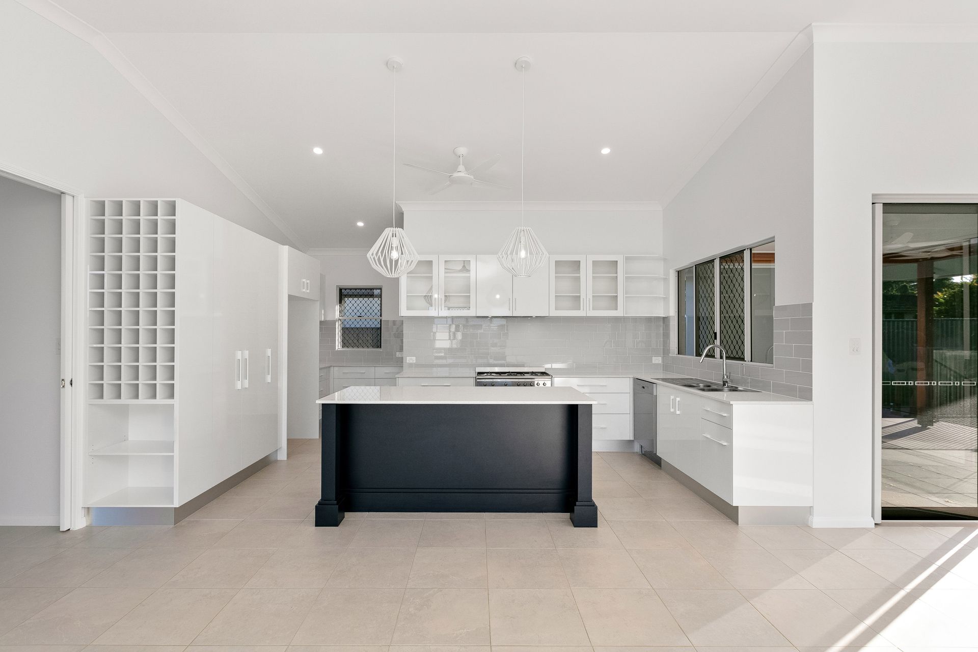 A Modern Kitchen With White Cabinetry — Ashlee Jones Homes in Gordonvale, QLD