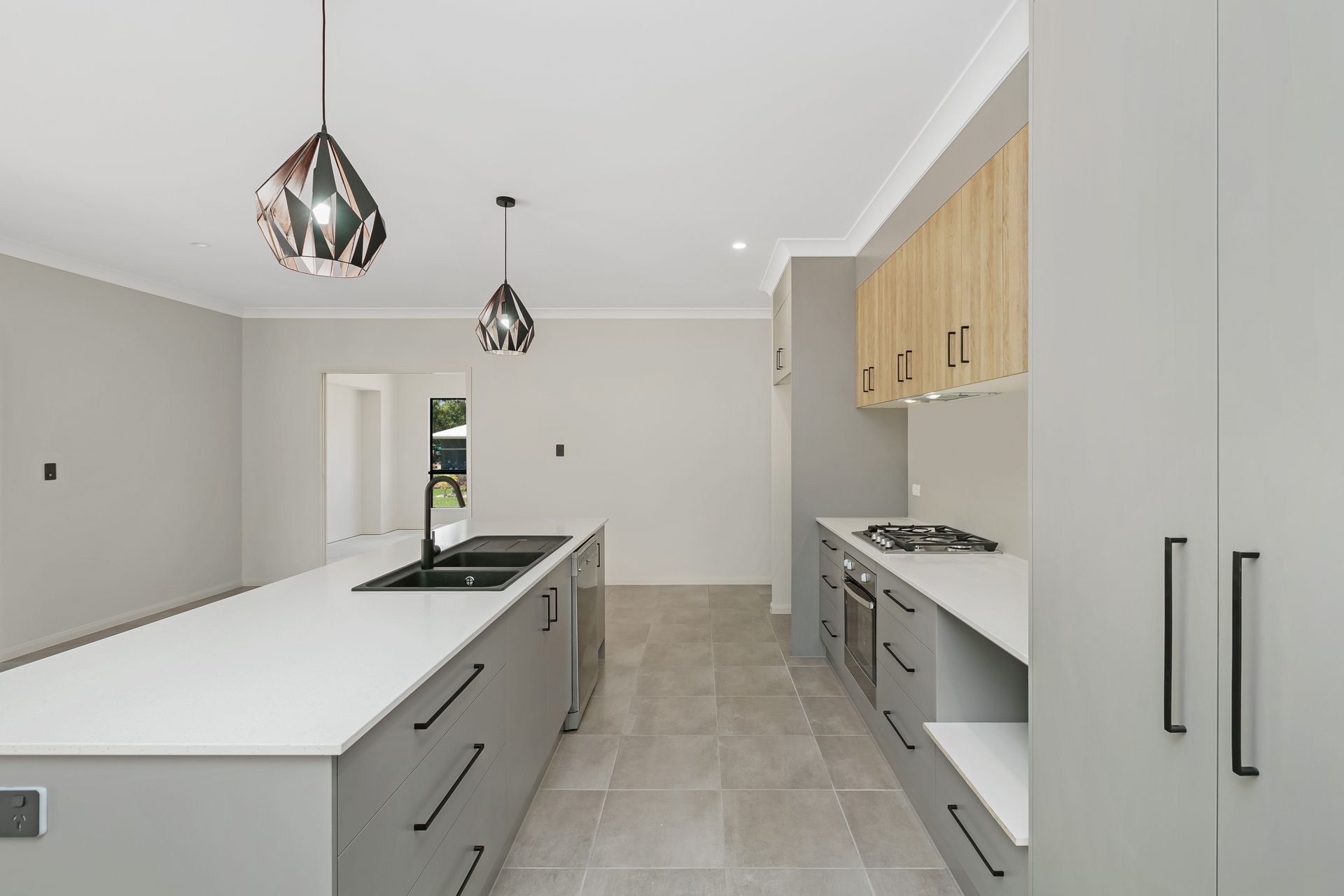 Modern Kitchen With Grey Cabinets, Light Wood Cupboards — Ashlee Jones Homes in Gordonvale, QLD