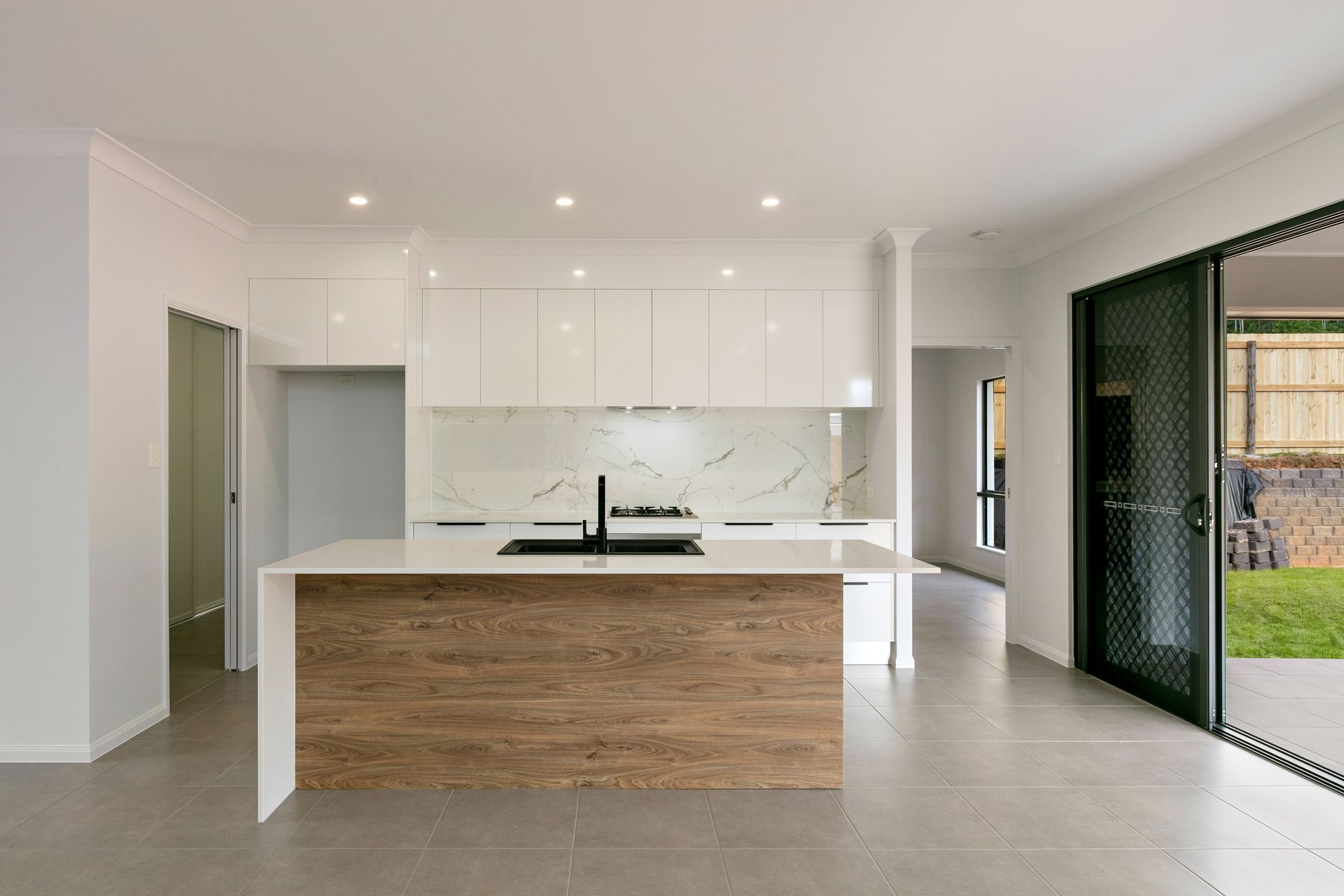 Modern Kitchen With a White Marble-look Backsplash — Ashlee Jones Homes in Gordonvale, QLD