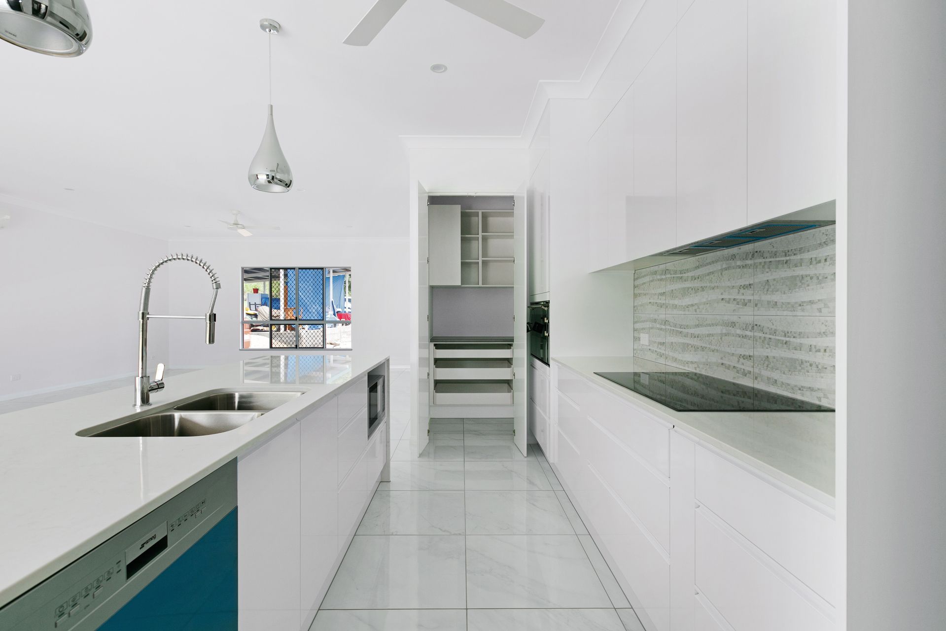 A Modern, Minimalist White Kitchen With a Center Island — Ashlee Jones Homes in Gordonvale, QLD