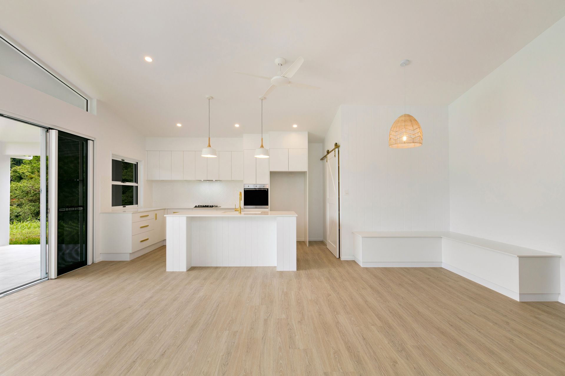 Modern, Minimalist Open-concept Kitchen With White Cabinetry — Ashlee Jones Homes in Gordonvale, QLD