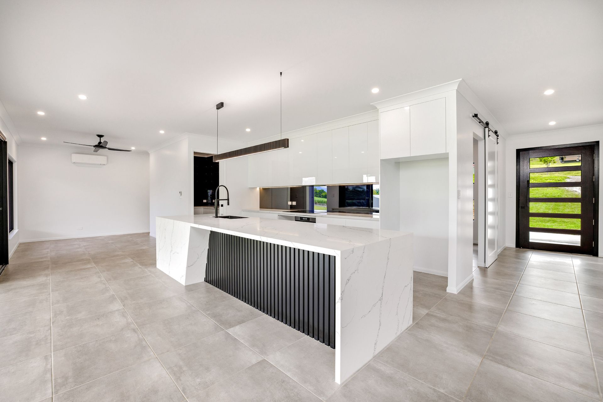 A Modern, Open-plan Kitchen With a White Quartz Island — Ashlee Jones Homes in Gordonvale, QLD