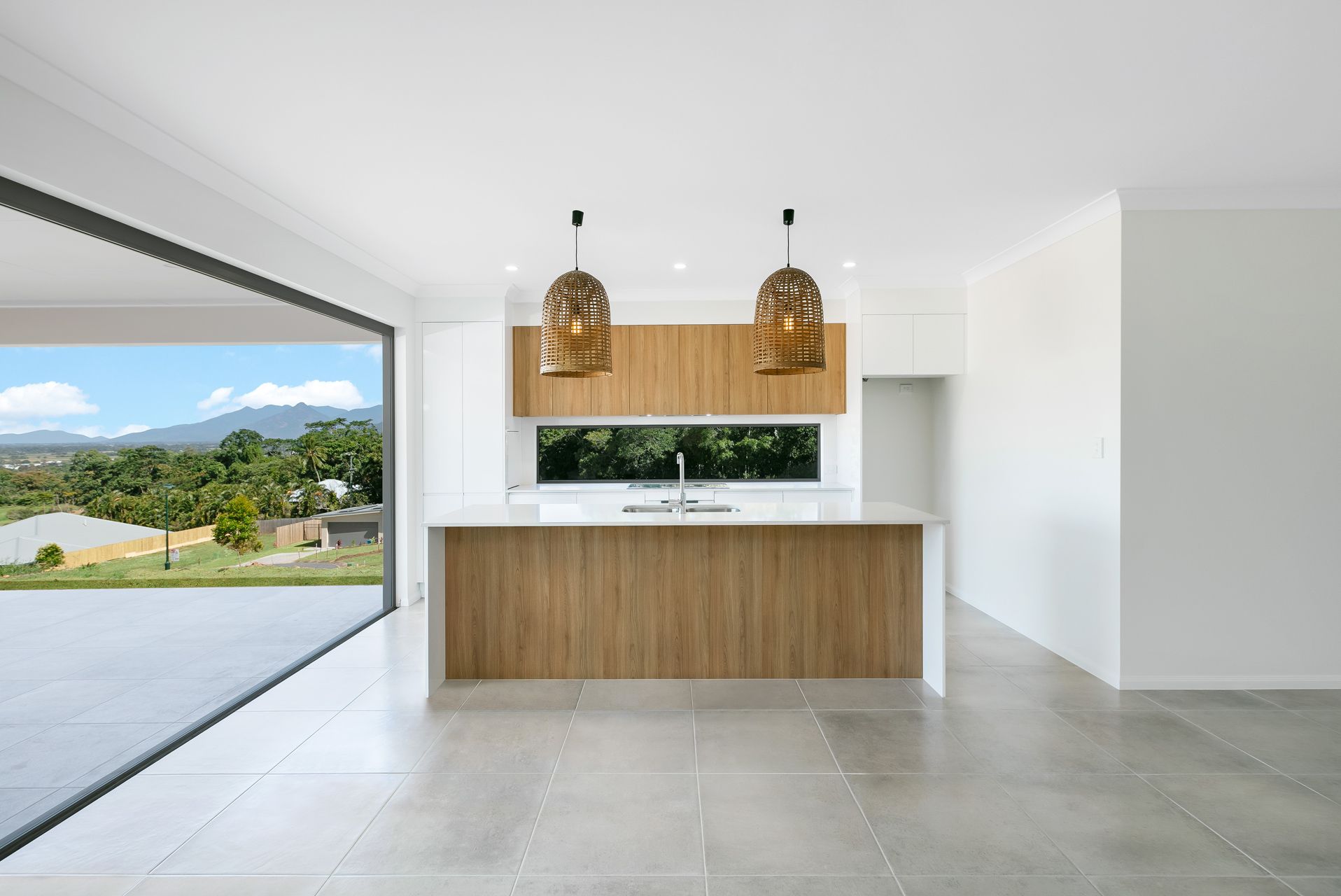 Modern Kitchen With a Wooden Island, Pendant Lights — Ashlee Jones Homes in Gordonvale, QLD
