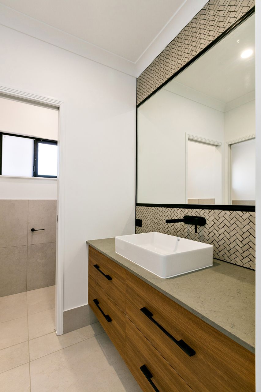 A Bathroom Vanity With a White Vessel Sink — Ashlee Jones Homes in Gordonvale, QLD